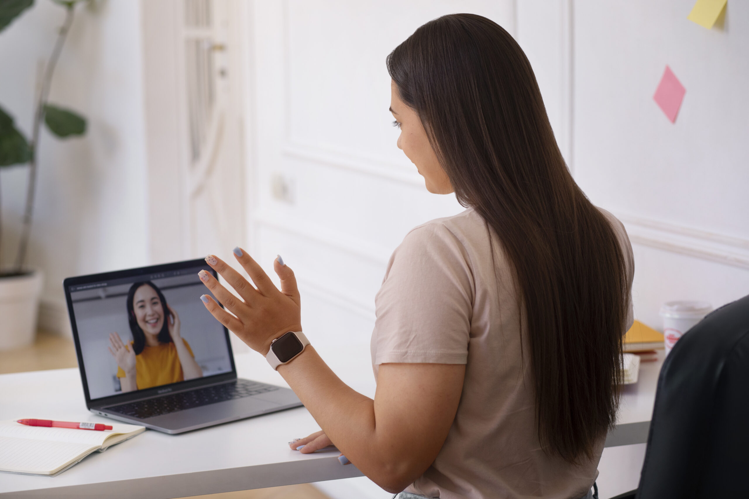 woman having videocall using laptop device from home 1 scaled